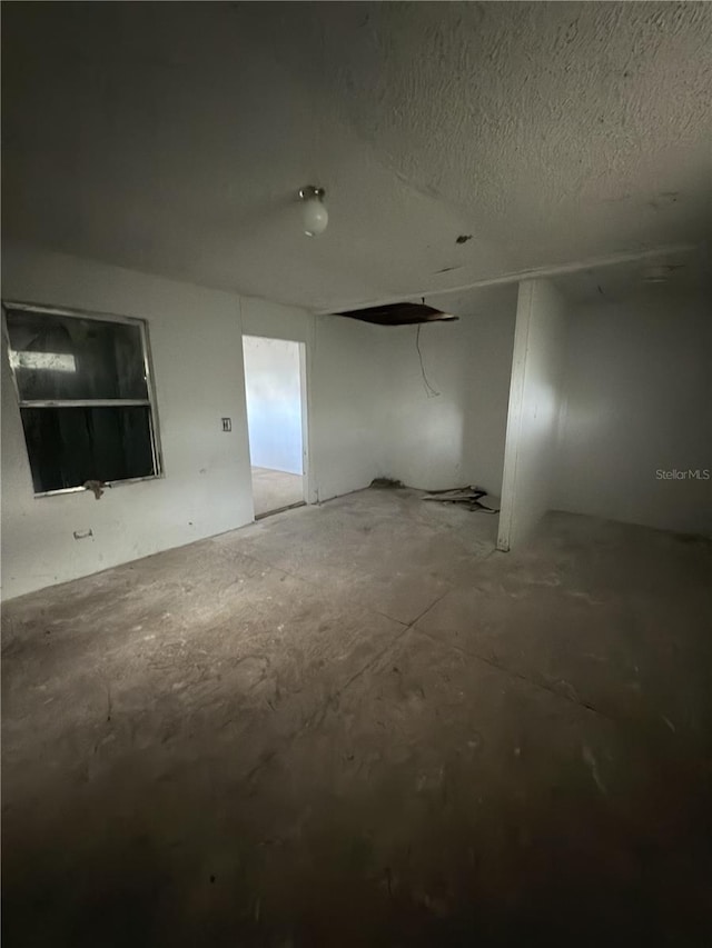 unfurnished room featuring a textured ceiling