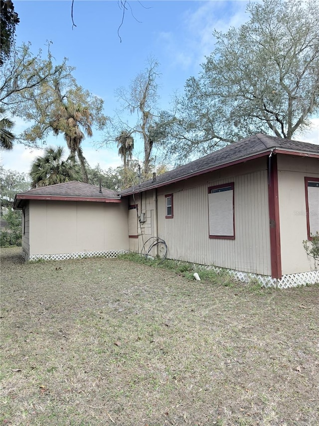 view of property exterior with a lawn