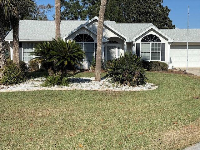 single story home featuring a front yard and a garage