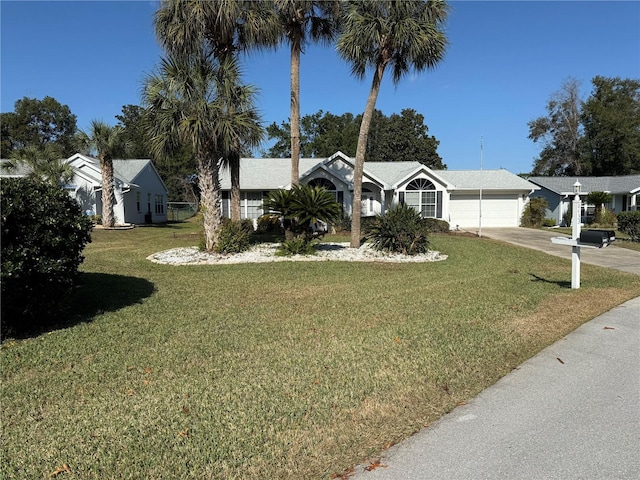 ranch-style home with a front lawn and a garage