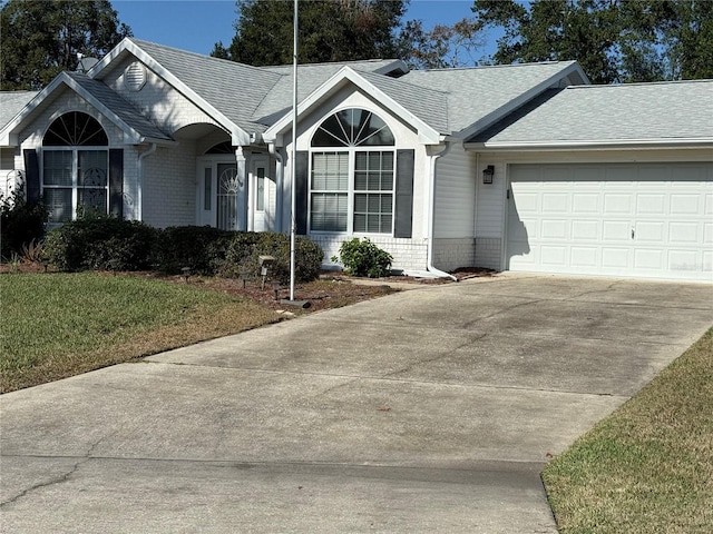 ranch-style house featuring a front yard and a garage