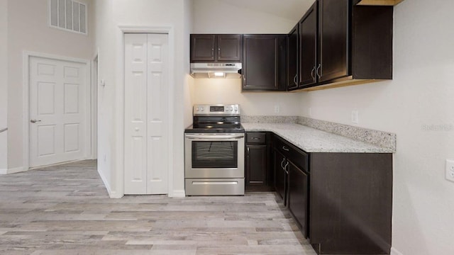 kitchen featuring dark brown cabinetry, light hardwood / wood-style floors, light stone counters, and stainless steel electric stove