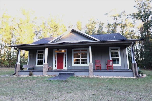 view of front of home with covered porch and a front yard