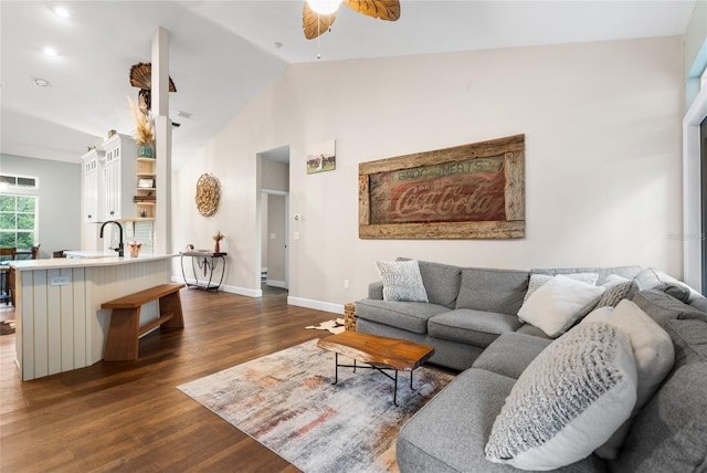 living room featuring dark wood-type flooring, ceiling fan, and lofted ceiling