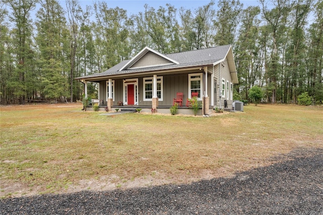 view of front of home featuring central AC, a front yard, and a porch