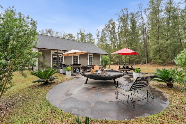 view of patio with a grill and a fire pit