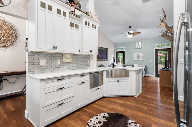 kitchen with white cabinetry, sink, ceiling fan, kitchen peninsula, and dark wood-type flooring