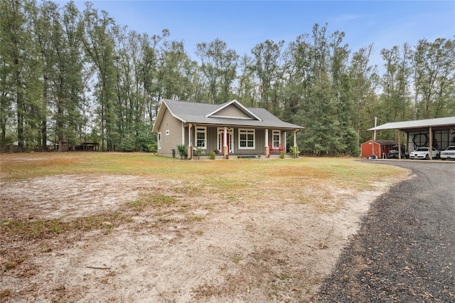 view of front of home featuring a carport, a porch, and a front lawn