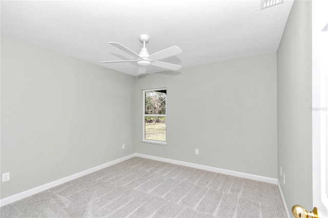 carpeted empty room featuring a textured ceiling and ceiling fan