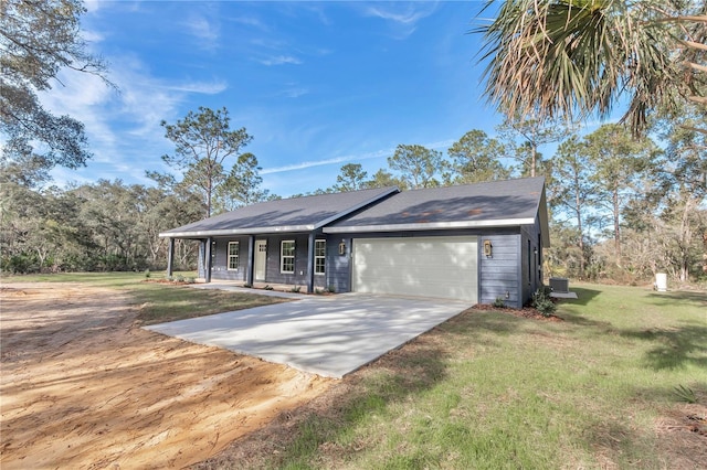 single story home featuring a front yard, a porch, and a garage