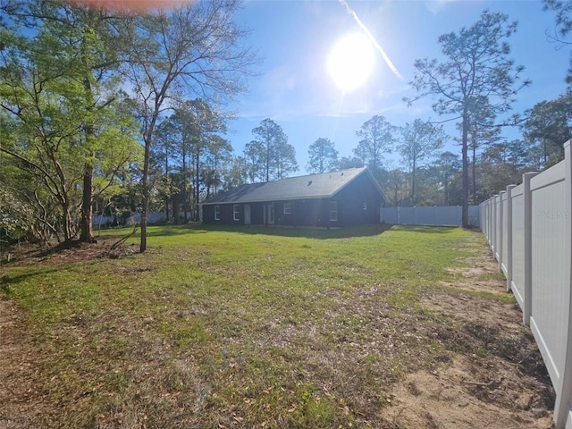 view of yard with a fenced backyard