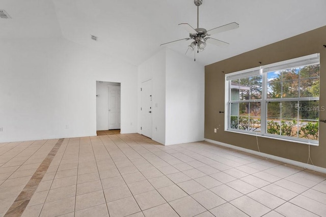 tiled spare room with ceiling fan and vaulted ceiling