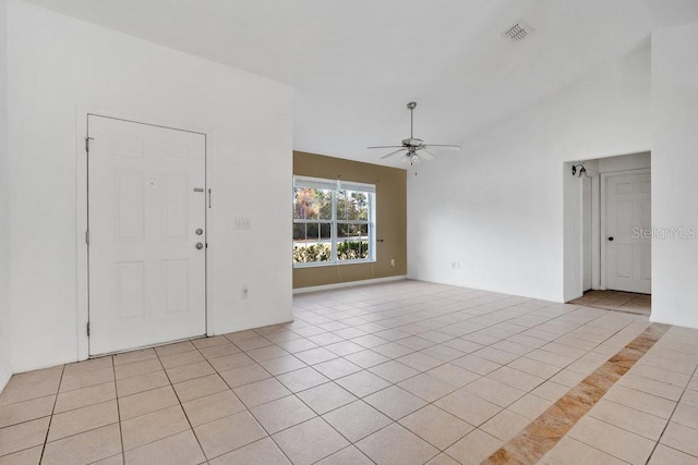 tiled foyer entrance featuring ceiling fan and lofted ceiling