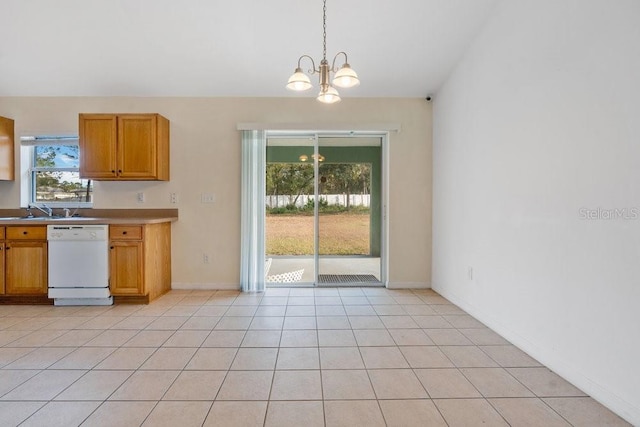 kitchen with dishwasher, light tile patterned floors, hanging light fixtures, and an inviting chandelier