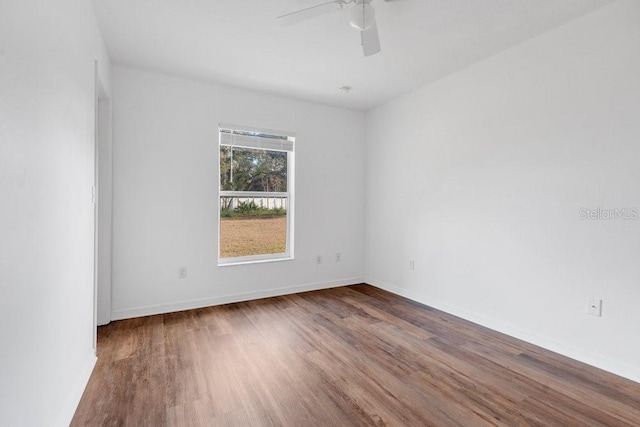 spare room with wood-type flooring and ceiling fan