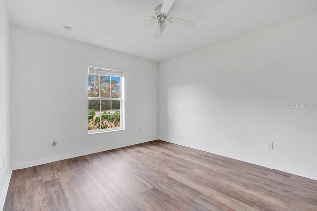 unfurnished room with ceiling fan and light wood-type flooring