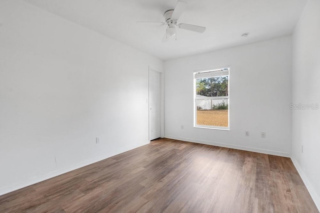 unfurnished room with hardwood / wood-style floors and ceiling fan