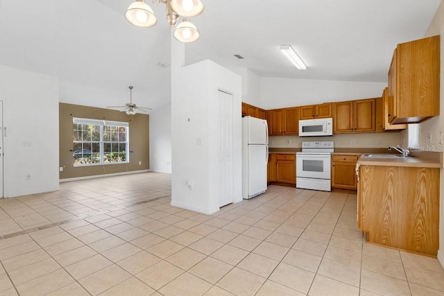 kitchen featuring ceiling fan with notable chandelier, light tile patterned floors, white appliances, and sink