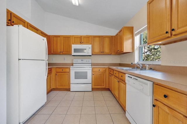 kitchen with light tile patterned floors, white appliances, vaulted ceiling, and sink