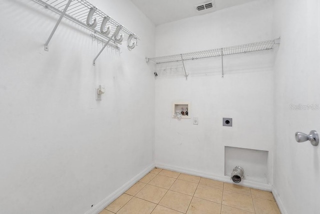 washroom featuring hookup for a washing machine, light tile patterned floors, and electric dryer hookup