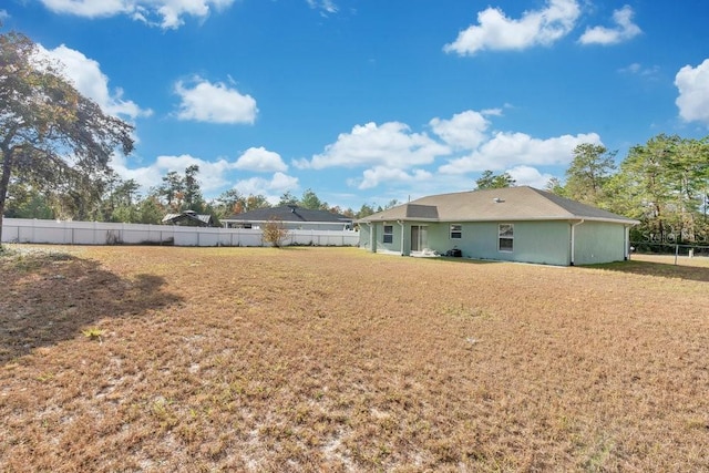 rear view of property with a lawn