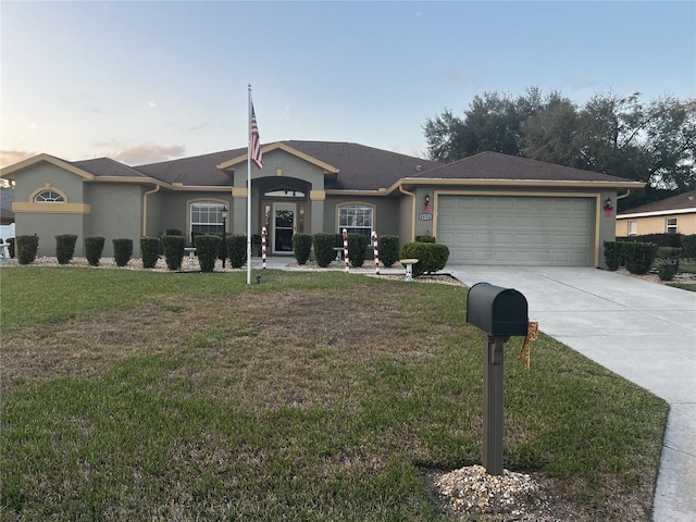 single story home with a lawn and a garage