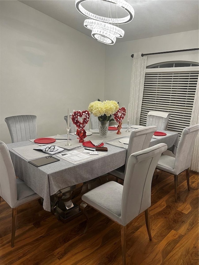 dining area featuring dark hardwood / wood-style floors and a notable chandelier