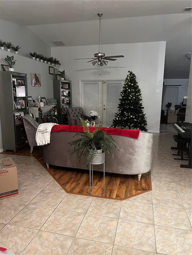 living room featuring ceiling fan, french doors, and light tile patterned floors