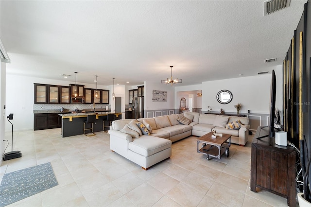 tiled living room featuring an inviting chandelier