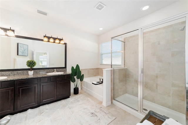 bathroom with tile patterned flooring, vanity, and separate shower and tub