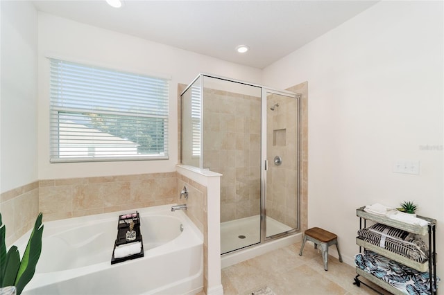 bathroom featuring tile patterned flooring and separate shower and tub