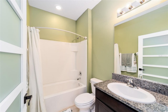 full bathroom with shower / bath combo with shower curtain, vanity, and toilet