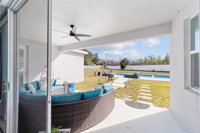 view of patio / terrace featuring a fenced in pool and ceiling fan