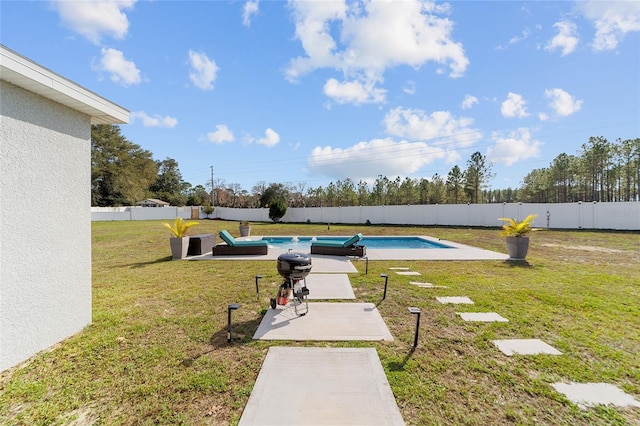 view of yard featuring a fenced in pool and a patio