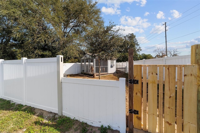 view of gate featuring an outdoor structure