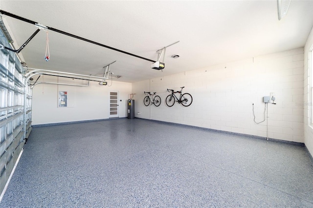 garage featuring electric panel, a garage door opener, and water heater