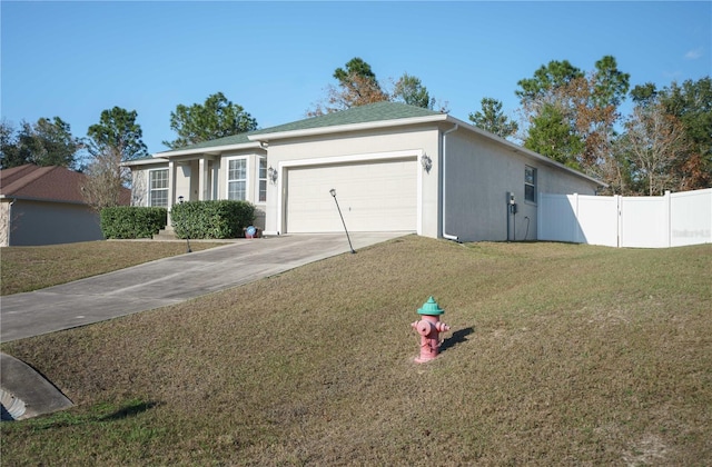 ranch-style home featuring a front lawn and a garage