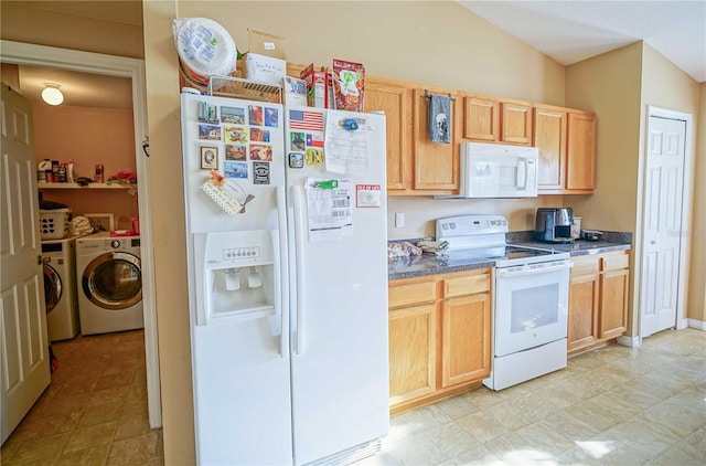 kitchen with lofted ceiling, light brown cabinets, washing machine and dryer, and white appliances