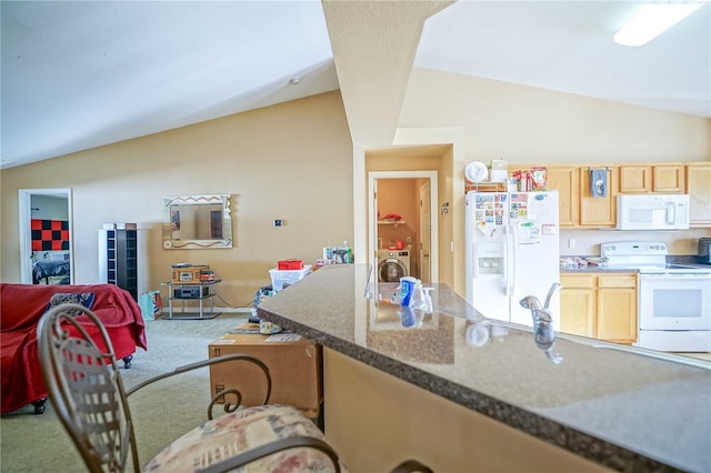 kitchen with carpet flooring, washer / dryer, lofted ceiling, white appliances, and light brown cabinetry