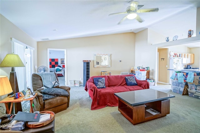 carpeted living room with ceiling fan and lofted ceiling