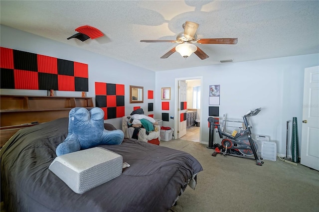 carpeted bedroom with ceiling fan, a textured ceiling, and connected bathroom