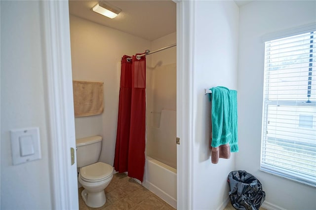 bathroom with shower / tub combo and toilet