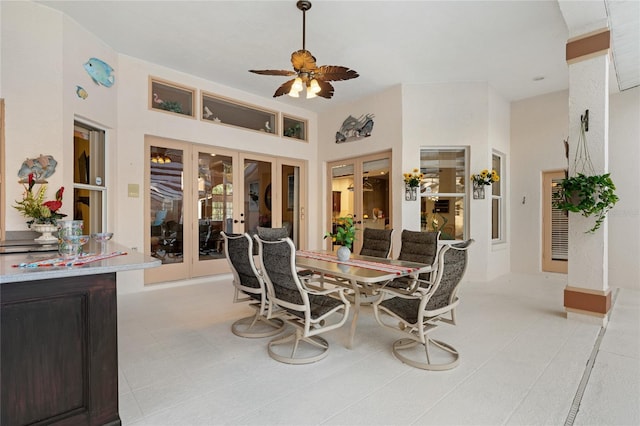 tiled dining space featuring ceiling fan and french doors