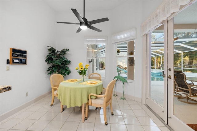 dining area featuring ceiling fan, light tile patterned flooring, and french doors