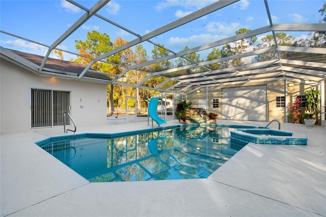 view of pool with a lanai, a patio area, and an in ground hot tub