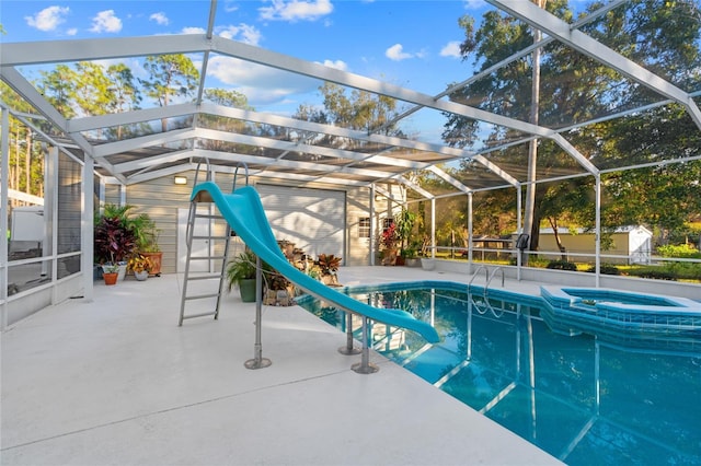 view of swimming pool featuring a patio, a lanai, an in ground hot tub, and a water slide