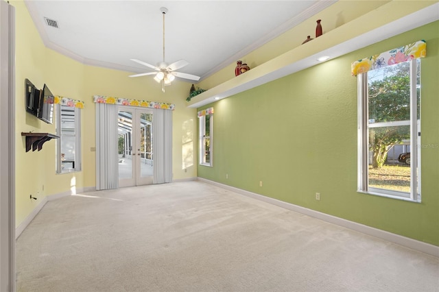 carpeted empty room with ceiling fan and ornamental molding