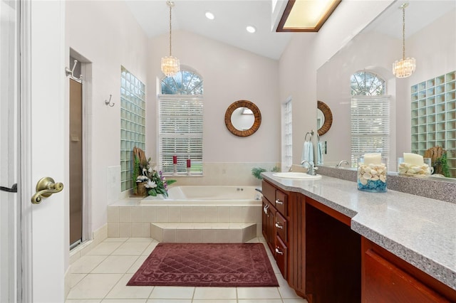 bathroom featuring a chandelier, shower with separate bathtub, tile patterned floors, and lofted ceiling