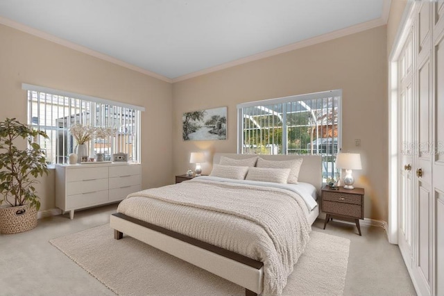 bedroom featuring light colored carpet, crown molding, and a closet