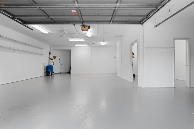 garage with a garage door opener and ceiling fan